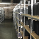 A warehouse hallway flanked on either side by stacks and stacks of PS4 Pros.